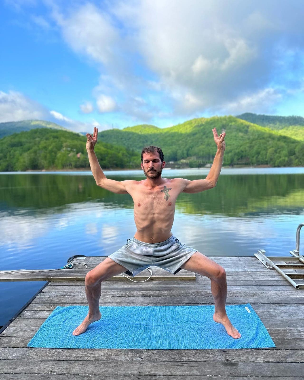 Mark Vajen (Yogi Manu) practicing goddess pose outdoors
